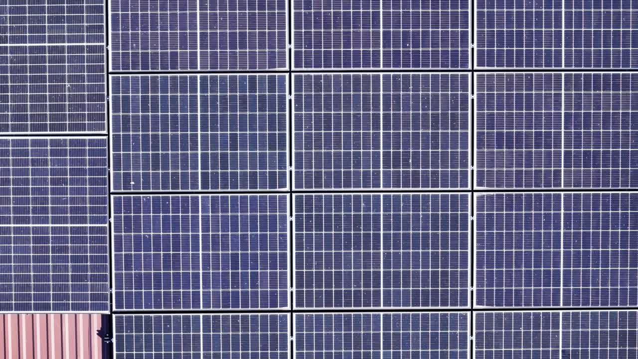 Dirty solar panel on top of rooftop, aerial drone top down view