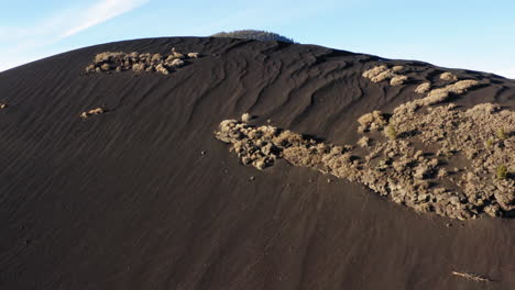 black sand dune with volcanic mountain at sunset crater, flagstaff - drone flying shot