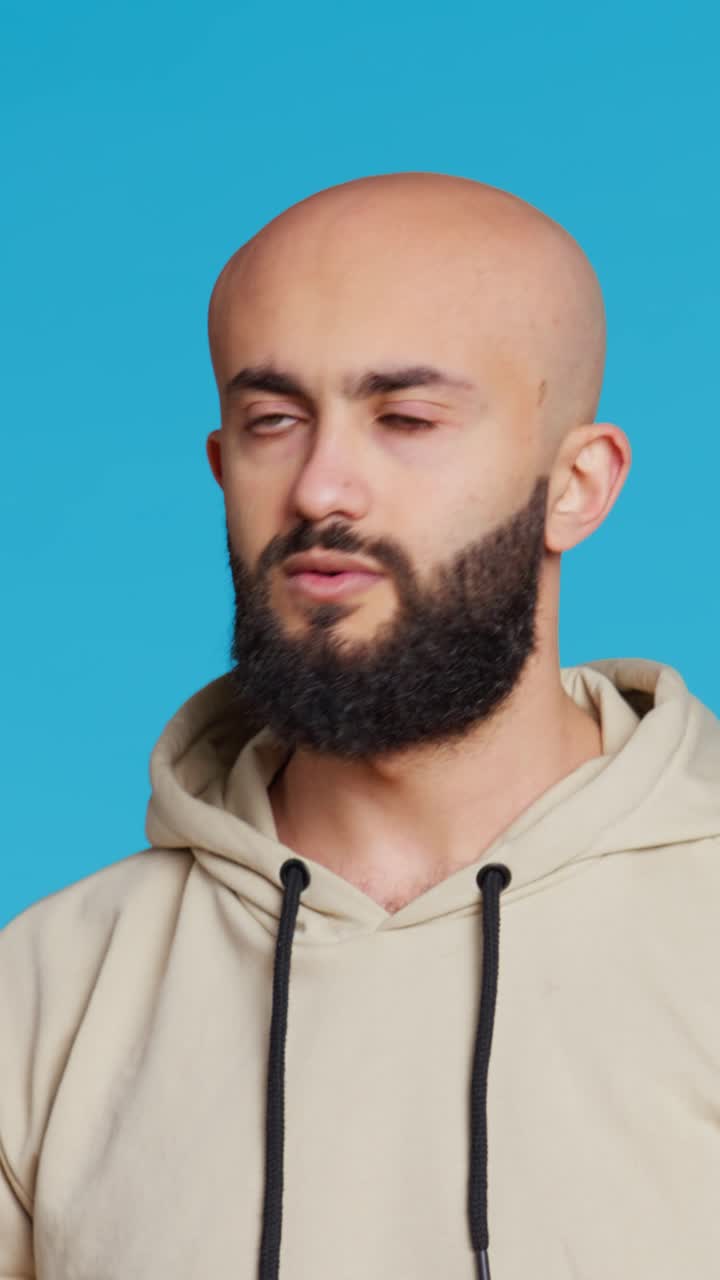 Vertical Video Young guy gesturing no sign over studio background