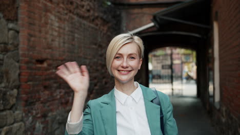woman in a green blazer in an urban setting