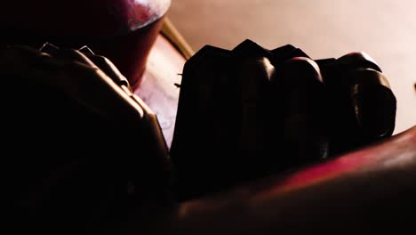 a pair of medieval gauntlets sit on a table as the camera slowly moves away from them