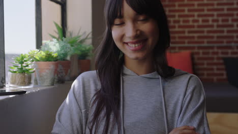 young asian woman smiling confident arms crossed enjoying successful lifestyle independent female student relaxing at home in modern apartment