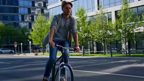 young man cycling on a city street