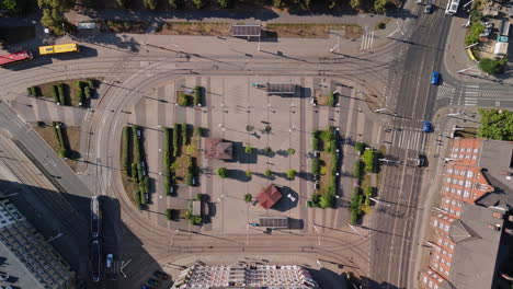 aerial view of a city square with tram tracks and public transport