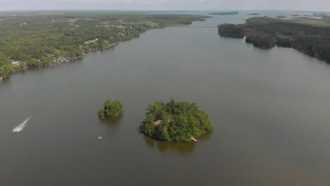 drone shot of a small island in the centre of a lake