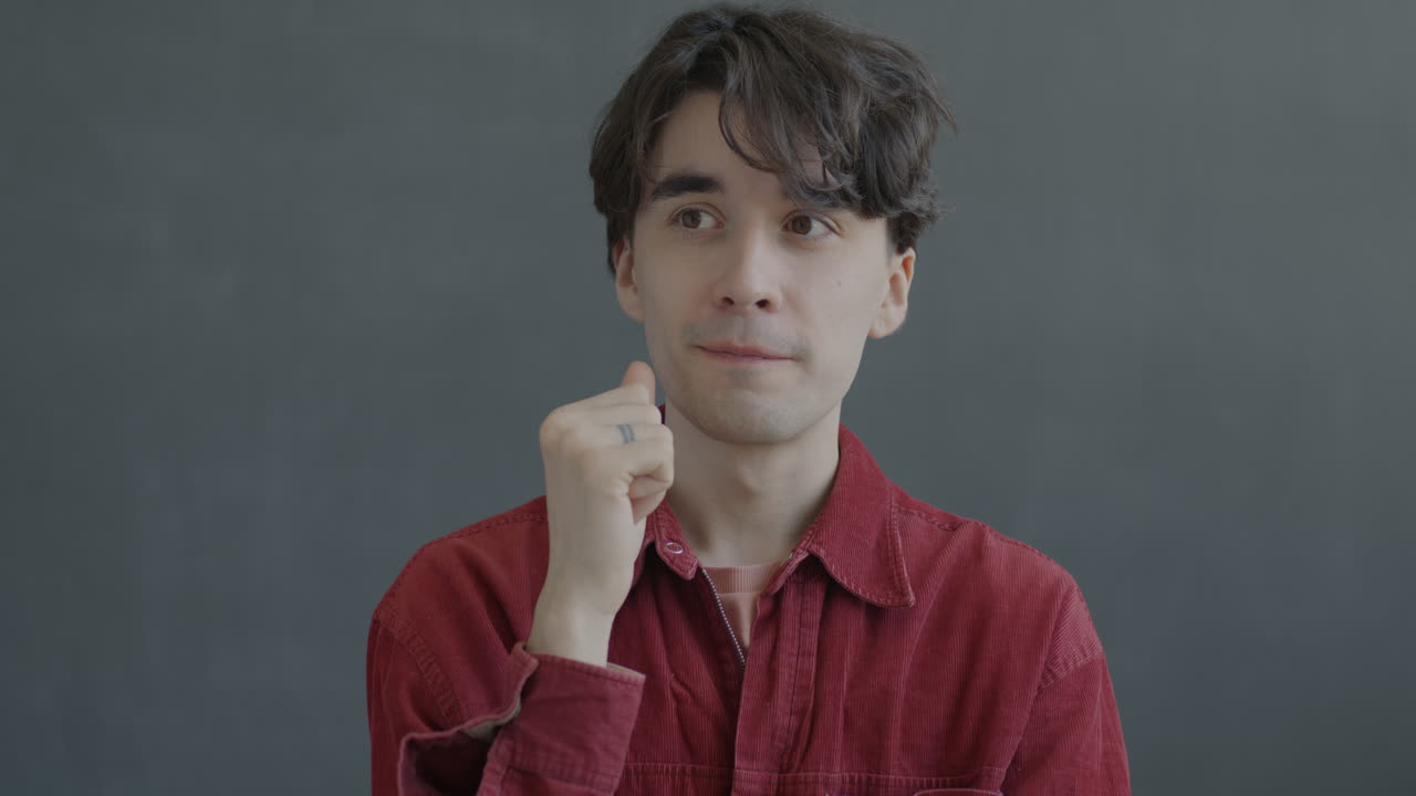 Thoughtful Young Man in Red Jacket