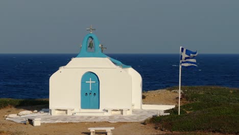 Small-orthodox-church-and-Greek-flag-in-slow-motion