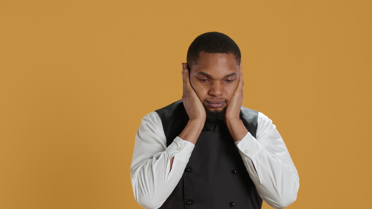 Restaurant staff covering his eyes, mouth and ears against evil in studio