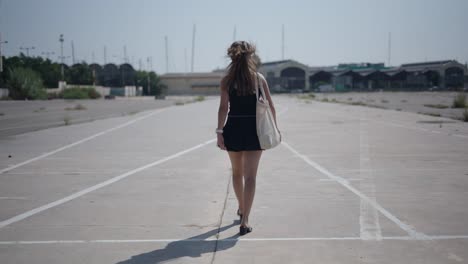 woman walking in an empty parking lot
