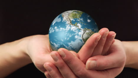 Woman-holding-a-rotating-Globe