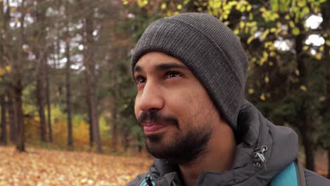 a hiker enjoys a serene mountain pause, sipping tea amid fall's beauty