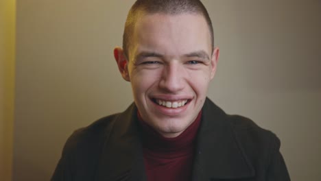 funny wide smile of a young handsome man looking at the camera - closeup shot