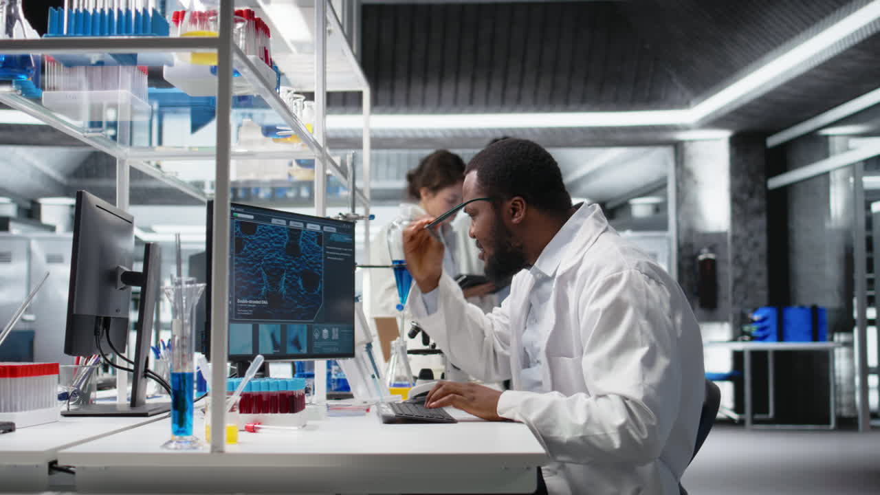 Vertical video Laboratory worker squinting eyes at computer, struggling to understand DNA data