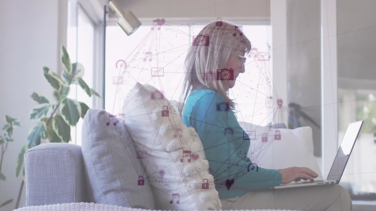 Using laptop at home, woman interacting with digital network animation icons