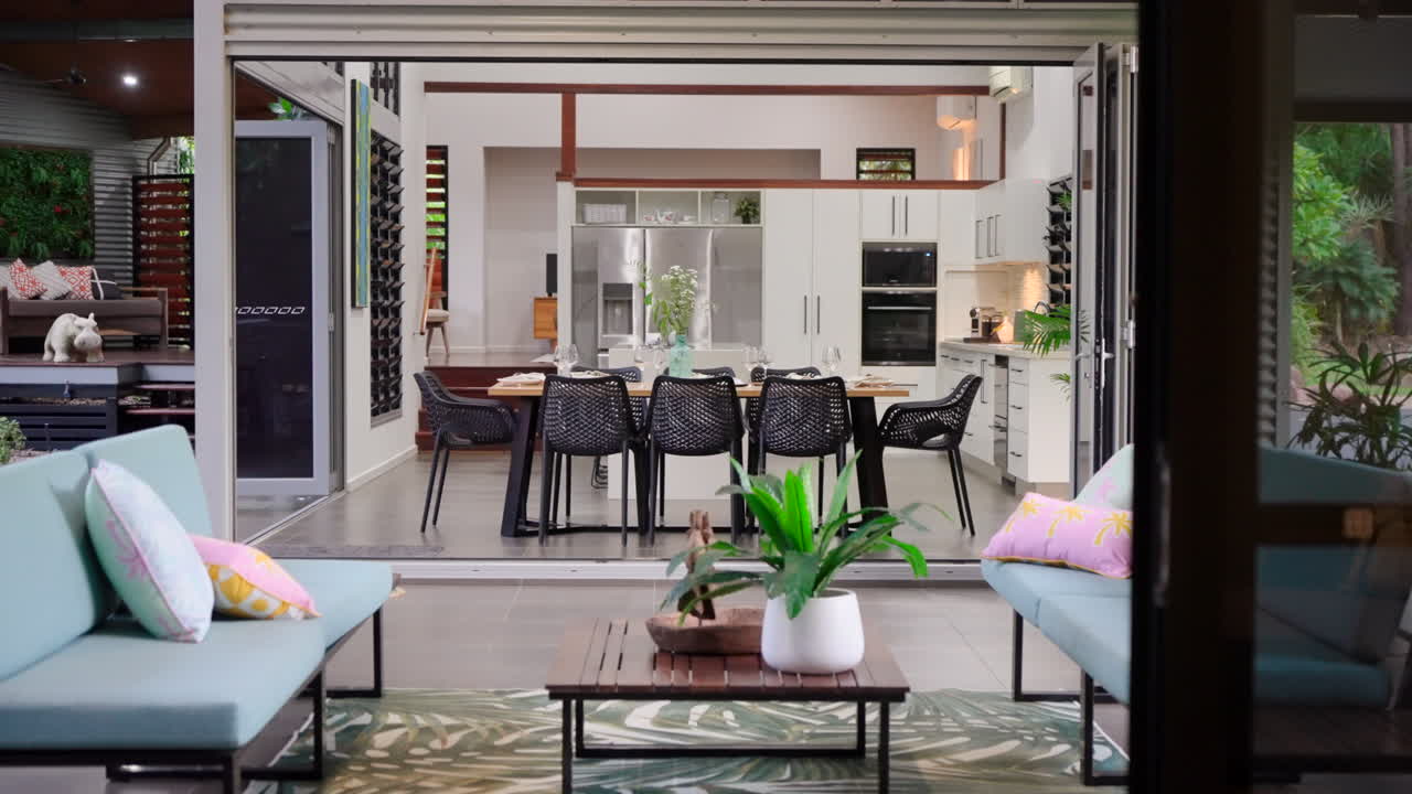 Prestigious modern tropical style open floor plan home with outdoor seating fully staged