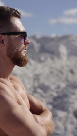 portrait of muscle man posing outdoor. strong man with naked torso standing on nature