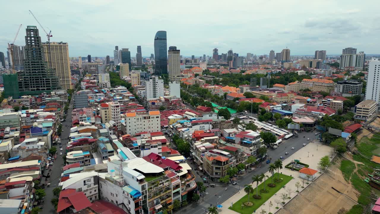 Phnom penh's urban landscape with tall buildings and colorful houses in daylight, aerial view