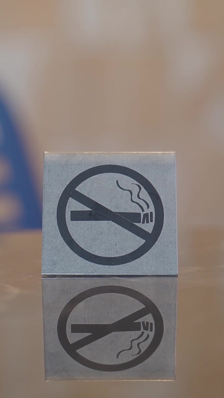 No Smoking Sign on a Reflective Surface