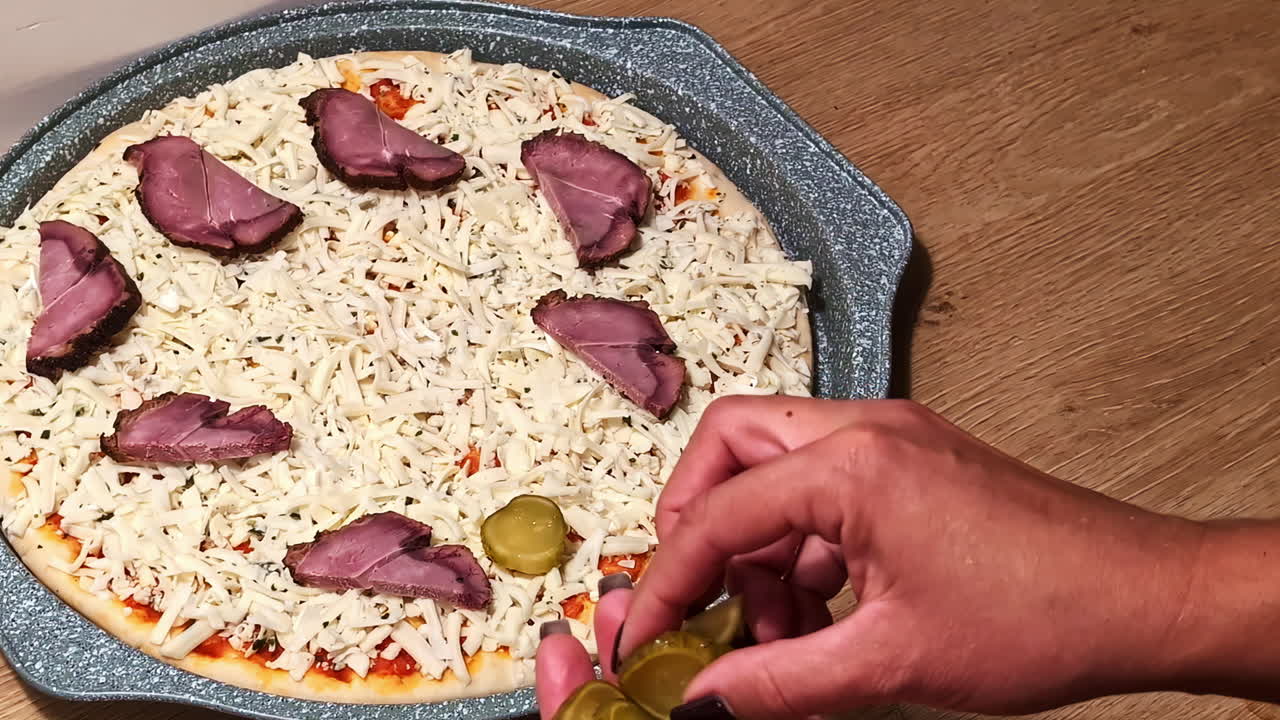 Fresh ingredients placed on homemade pizza, showing authentic food preparation in Latvia