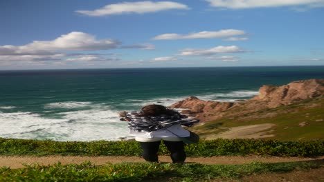 woman enjoying the view from a coastal viewpoint