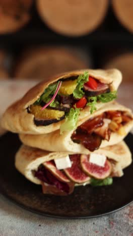 stack of pita sandwiches with various fillings