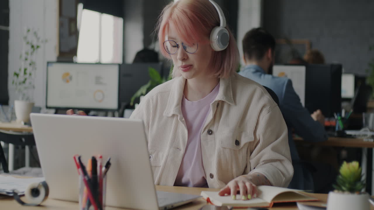 Woman working on a laptop in an office