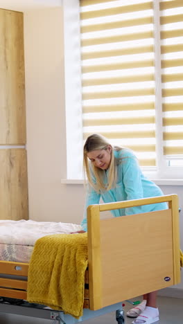 woman adjusting hospital bed