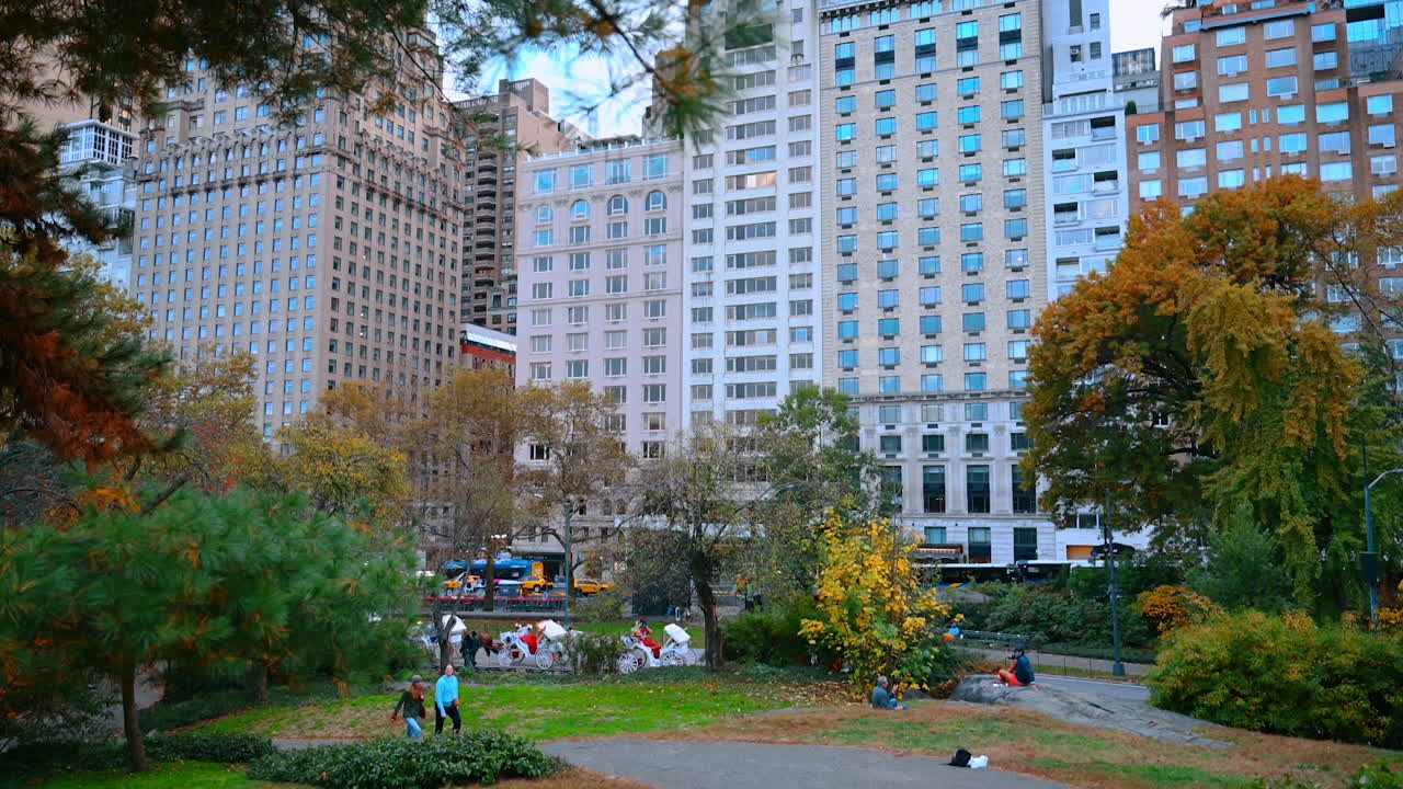 New York, USA, 8 October 2025: Central Park West View in Autumn. Urban skyline rises behind colorful fall foliage in Central Park