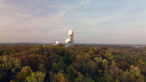 Calm-aerial-view-flight-pull-in-drone-at-autumn-forest-Radom-at-morning-sunrise,-devil's-mountain-in-woods-berlin-October-2022