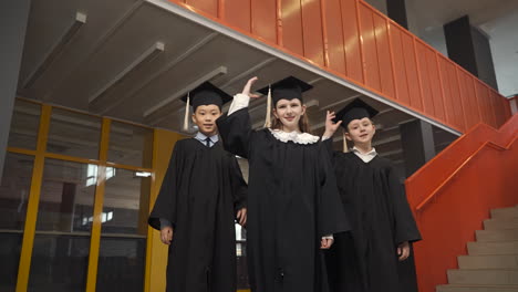 happy  students throwing their mortarboards up in the air