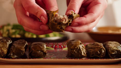 preparing delicious stuffed grape leaves (dolma)