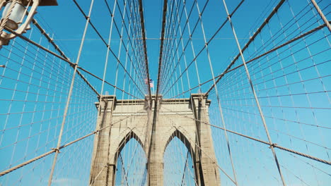 Walk-On-The-Brooklyn-Bridge-Pylons-And-Ropes-Of-The-Bridge-Against-The-Serene-Blue-Sky