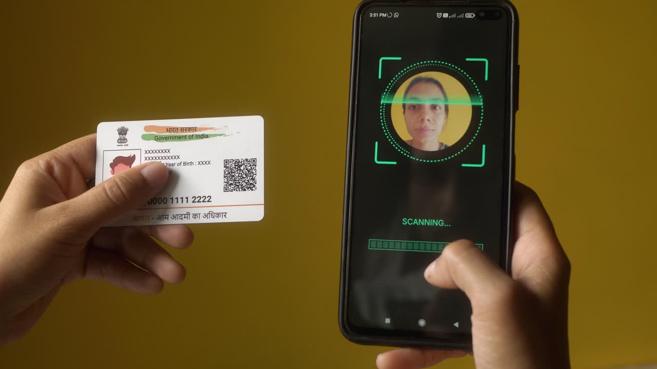 Indian nationality woman scanning her face on mobile phone for eKYC digital identity verification, Aadhaar card