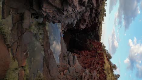 joffre gorge in karijini during sunset in western australia, vertical footage aerial tilting down