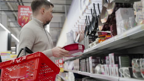 man shopping for kitchenware in a supermarket