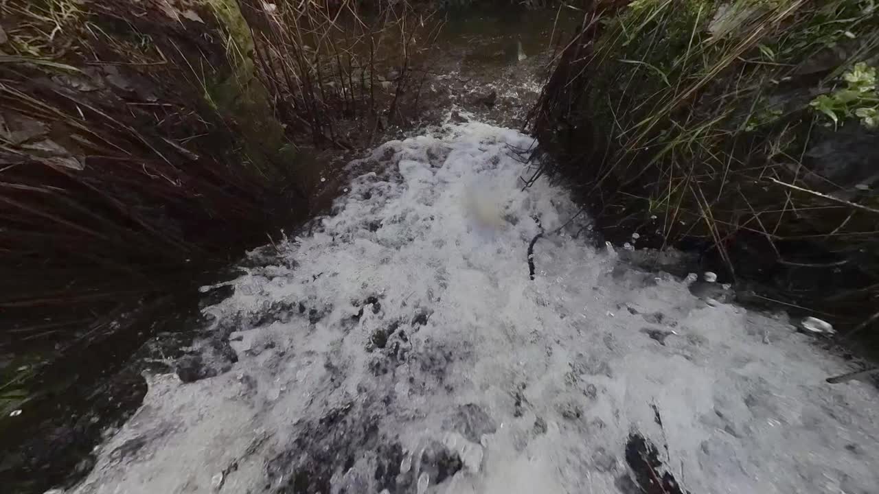 River overflow channel showing fast moving water