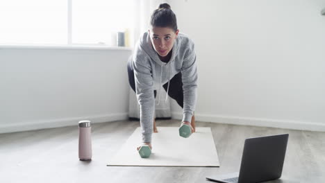 a young woman using a laptop while working out