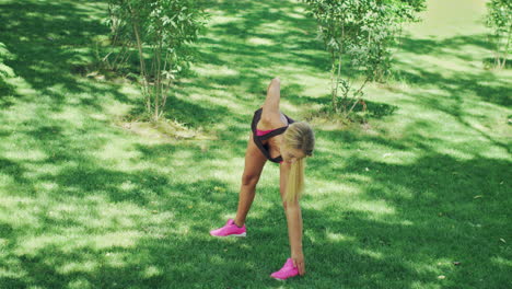 sport woman doing stretching exercise during workout in summer park. fit woman