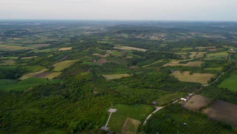 peaceful village in bosnia surrounded by forested hills – aerial shot