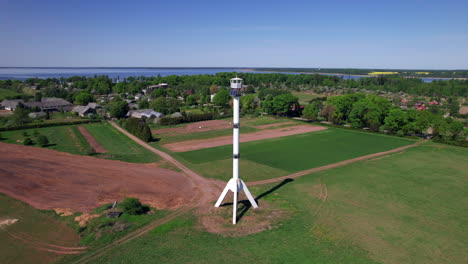 orbital shot of watchtower shaped like a rocket in burtnieku, latvia