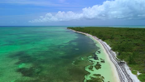 Aerial flyover Barker's Beach with white sand and blue Caribbean waters in Grand Cayman