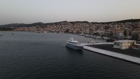 city argostoli, kefalonia, greece, drone backward establisher in blue hour, ship