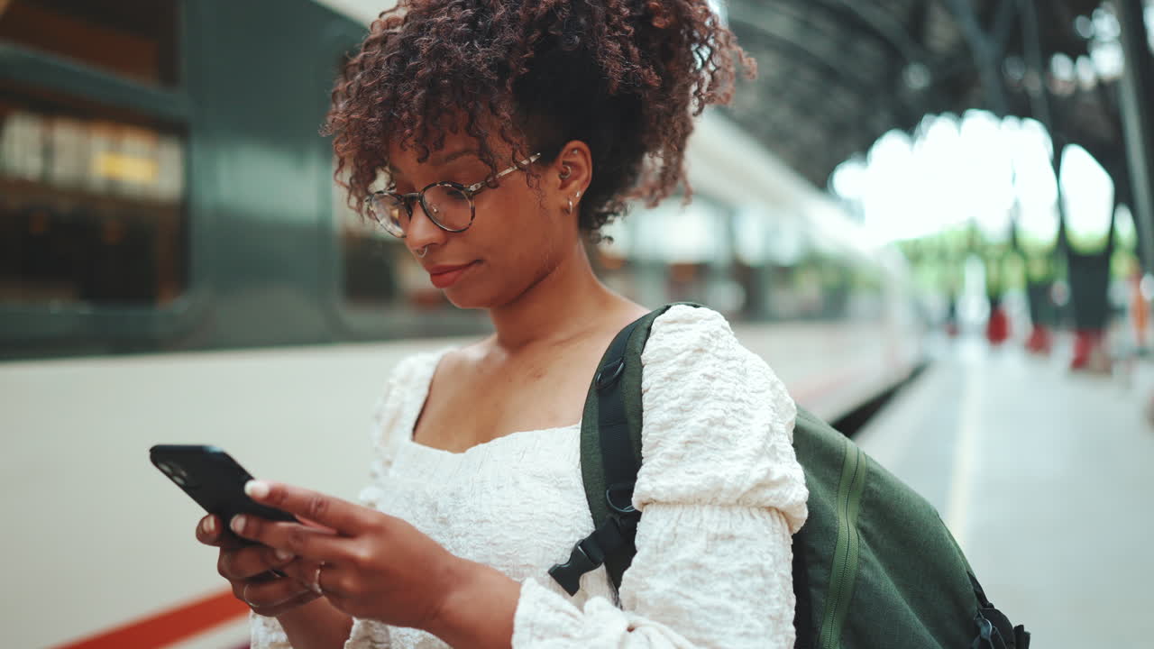 Woman using phone at train station
