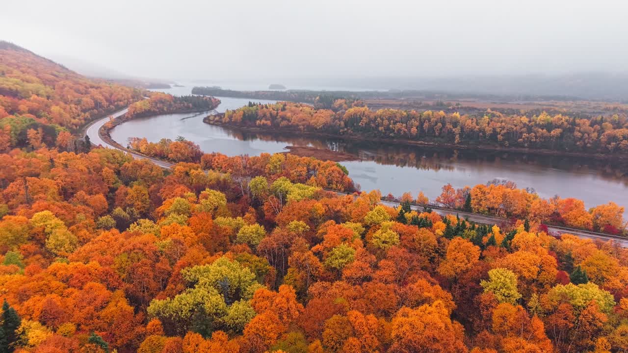 Drone footage shows foggy mountains shrouded in mist with steep escarpments