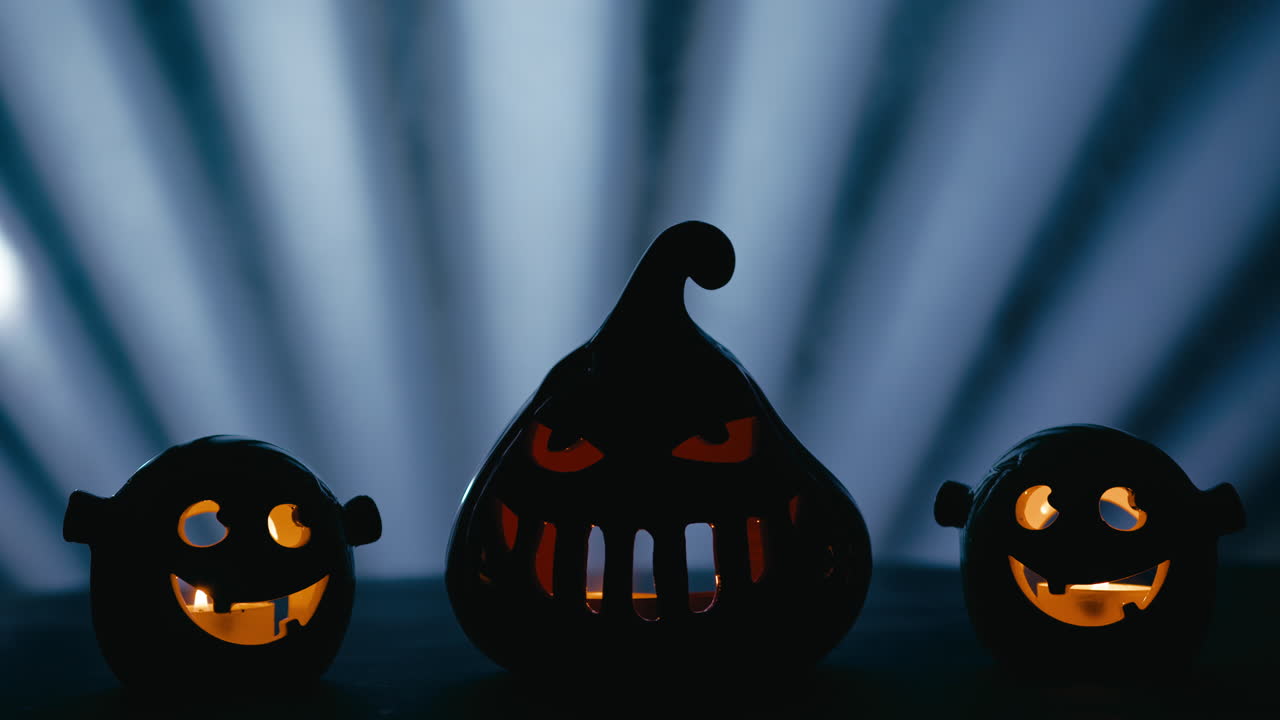 Glowing Halloween Pumpkins at Horror Night on Blue Background