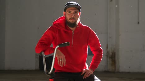 portrait of a bmx rider in an empty warehouse