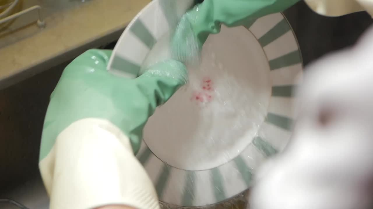 Washing a dish with gloves