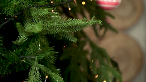 hands decorating a christmas tree