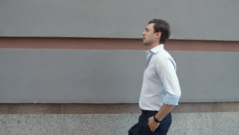 close up view of man walking near building