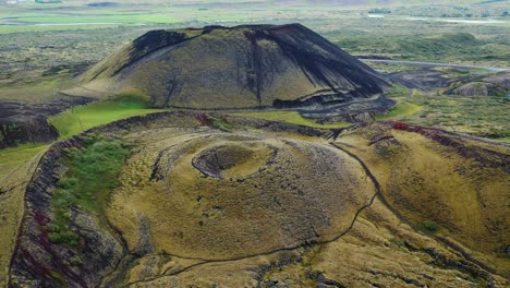 aerial drone flight over grabrok crater, iceland, 4k.